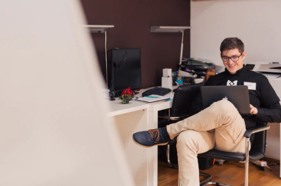 man smiling at laptop internal communications
