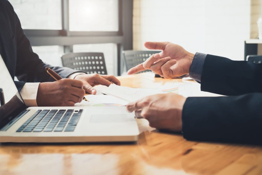 Two people working at table client meeting