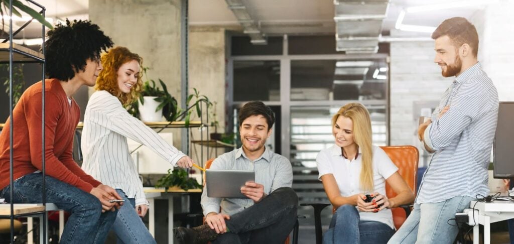 Group of people looking at ipad and smiling