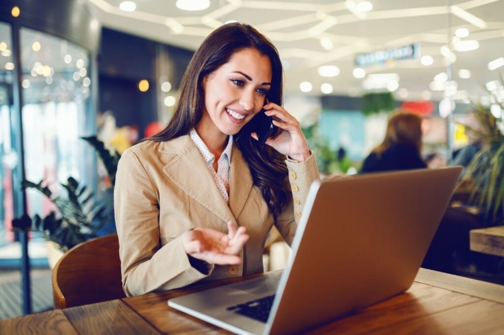 Woman with laptop talking on the phone