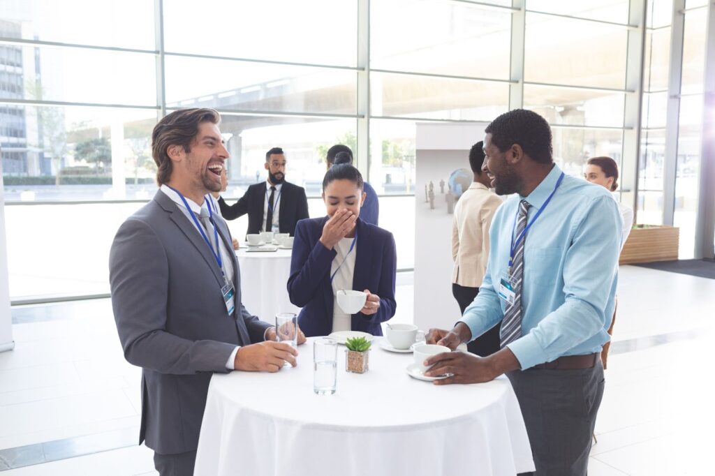 Three professional at networking events laughing