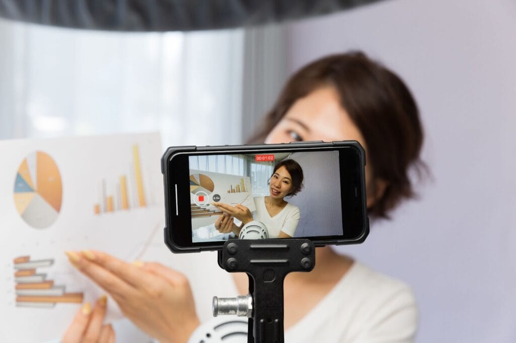 Woman recording video presenting financial information